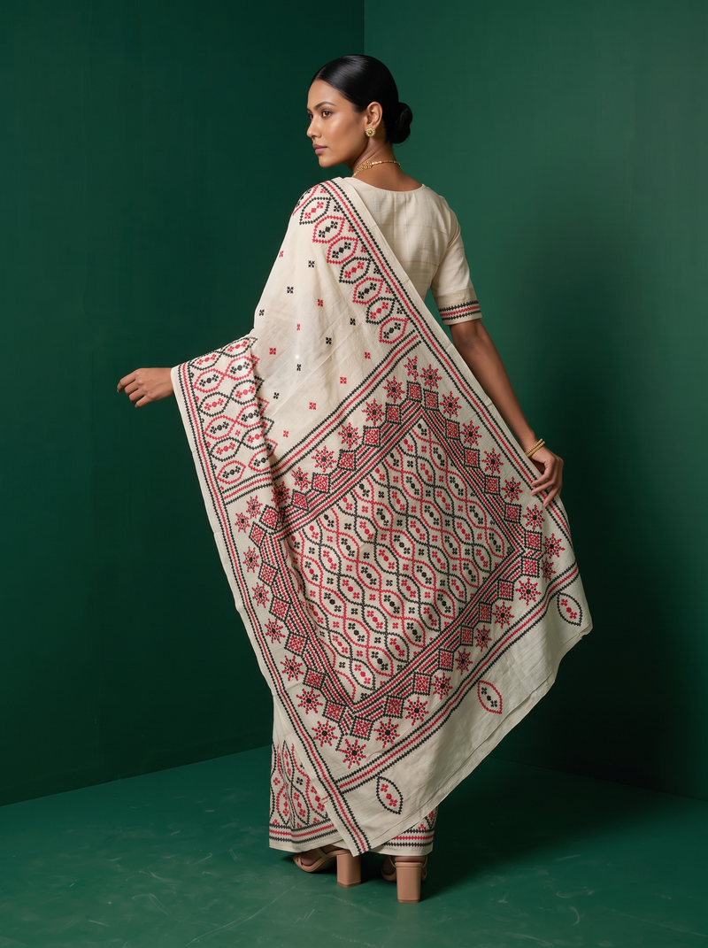 Earthy ivory silk meets bold red and black thread, stitched into medallions and stars in the Gujarati tradition. Handcrafted Gachi Tussar.