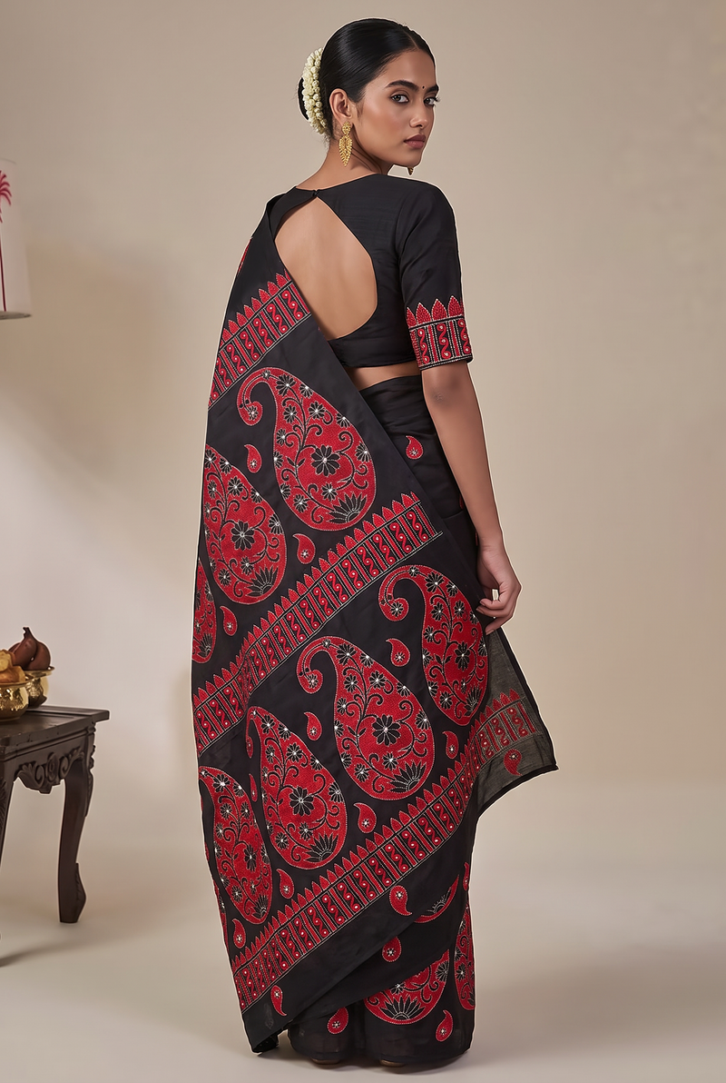 Midnight silk, crimson thread, women's hands. Kantha from Bolpur.
