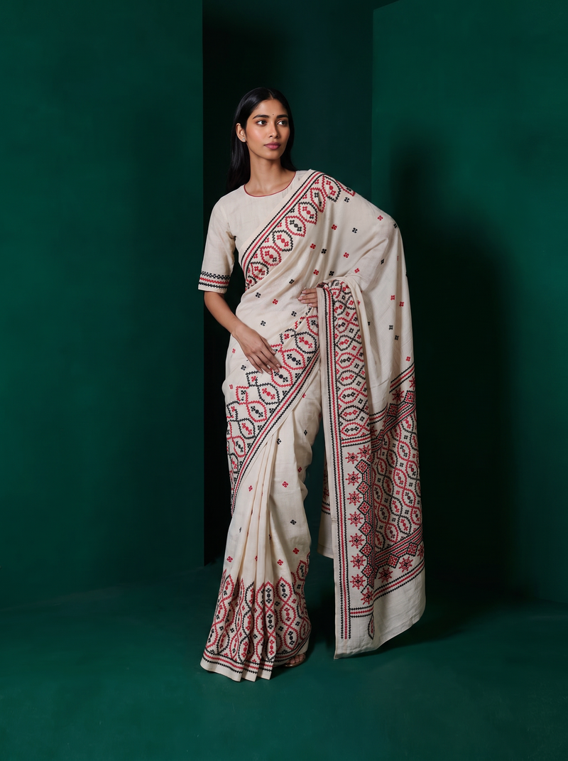 Earthy ivory silk meets bold red and black thread, stitched into medallions and stars in the Gujarati tradition. Handcrafted Gachi Tussar.