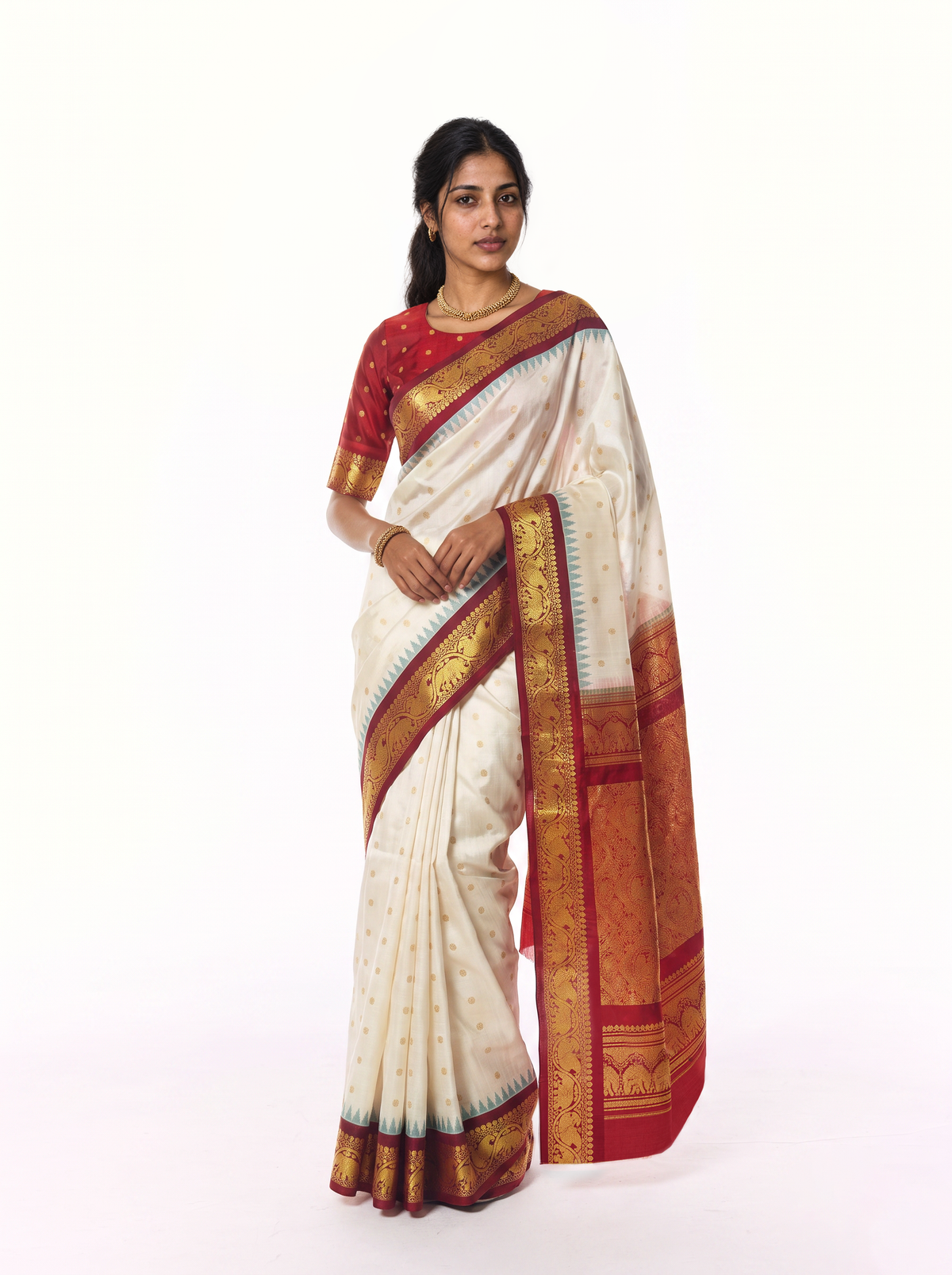 Soft cream scattered with gold, meeting rich maroon where zari elephants march through a golden jaal. Handloom Gadwal silk.