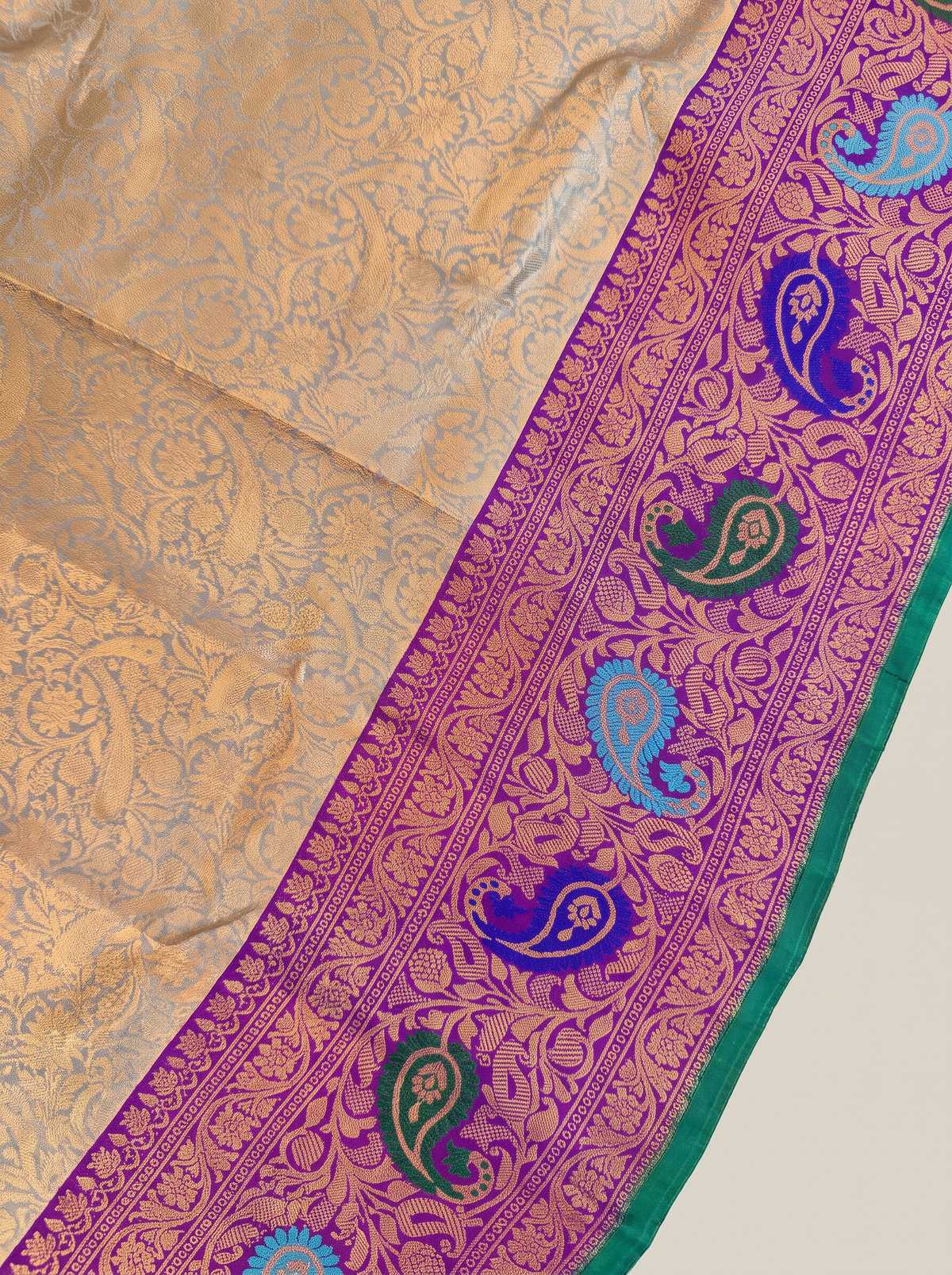 Golden dawn meets royal purple, bright with meenakari paisleys. Handloom Gadwal silk.