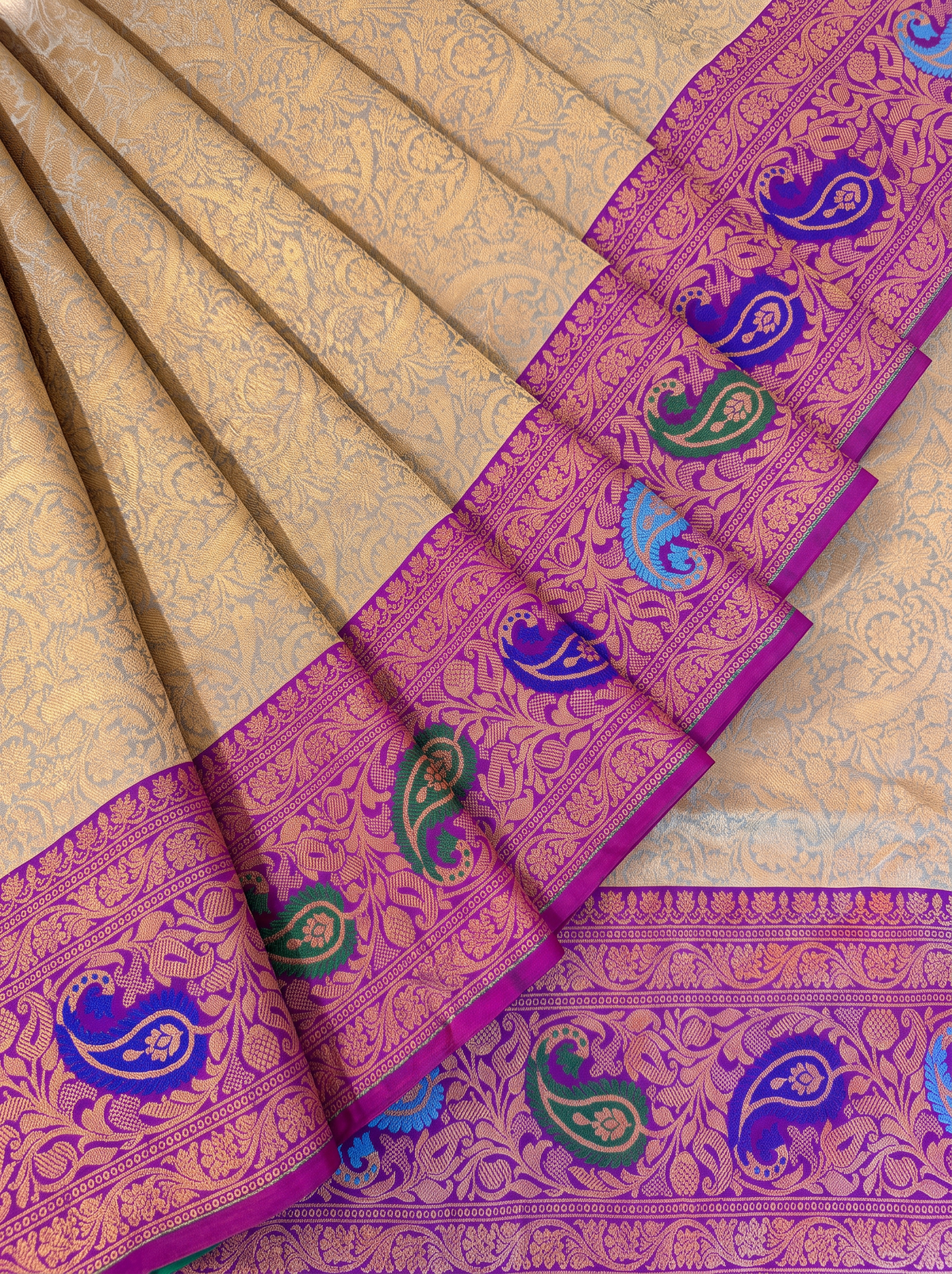 Golden dawn meets royal purple, bright with meenakari paisleys. Handloom Gadwal silk.