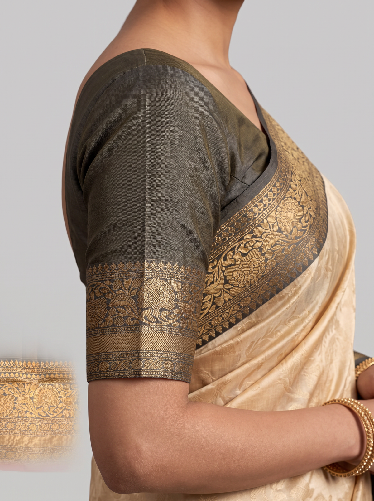 Like morning light on stone, soft cream meets warm grey, lit by a coral red edge and a shimmering gold zari jaal. Handloom Gadwal silk.