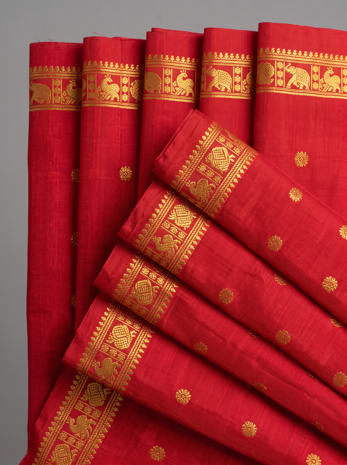 A timeless bridal red, glinting with gold. Handloom Gadwal silk with delicate buttis and a golden jaal border and pallu.