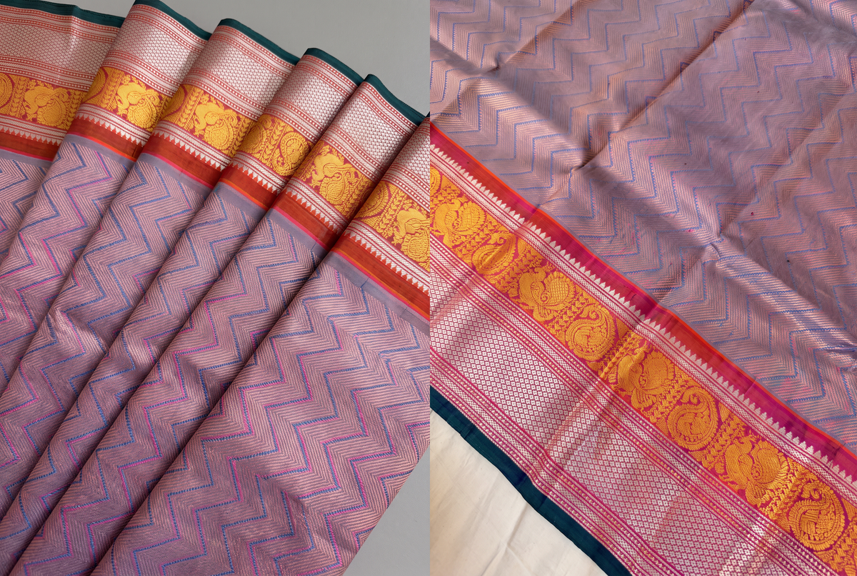 Lavender melting slowly into rust, like dusk settling over the hills. A brocade body framed by a Kanchi-style rust border, where gold peacocks and paisleys shimmer. Handloom Gadwal.