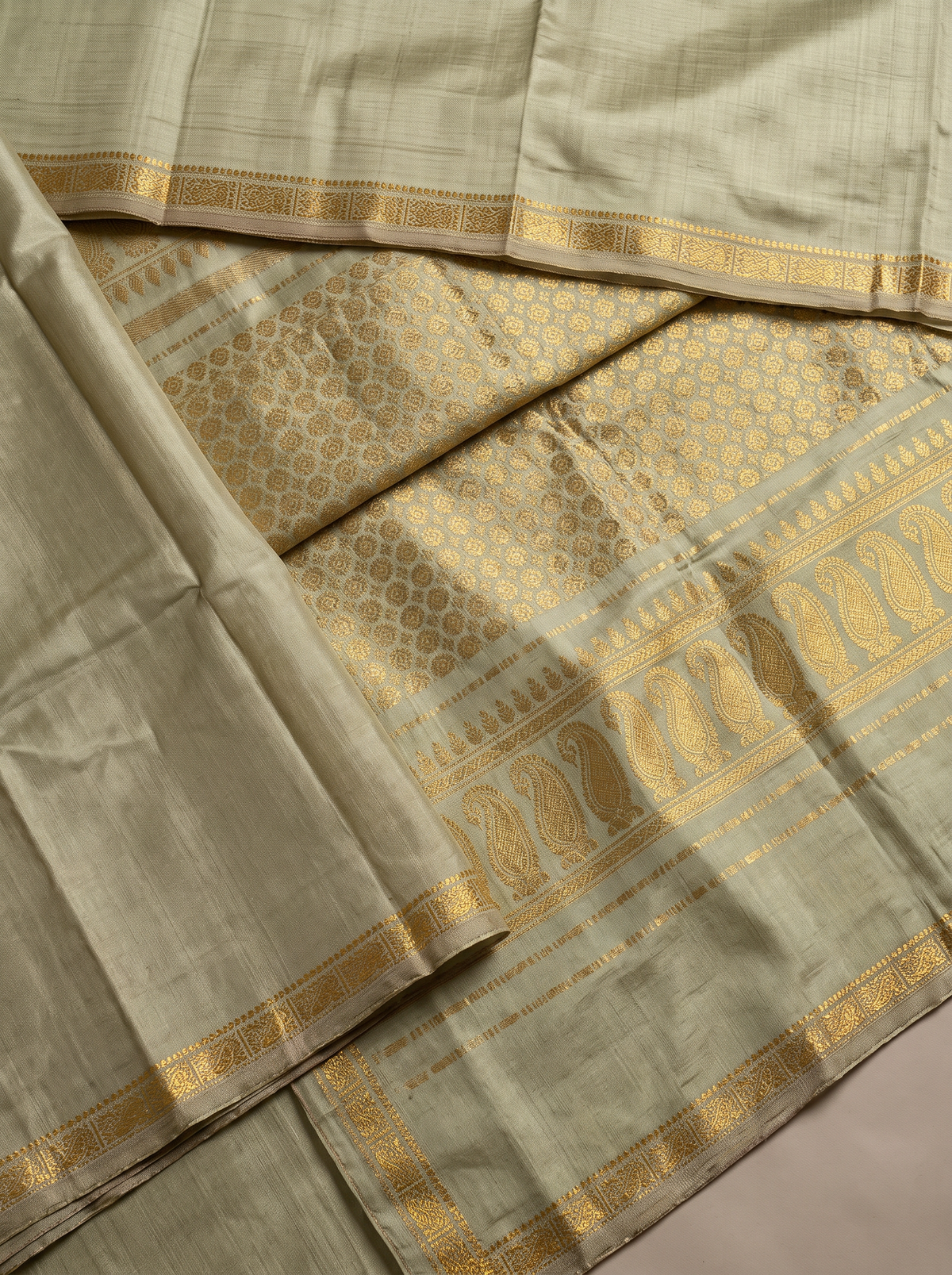 Quiet olive, glorious gold. A pure silk Gadwal with delicate zari borders and a richly woven pallu. Silk Mark certified.
