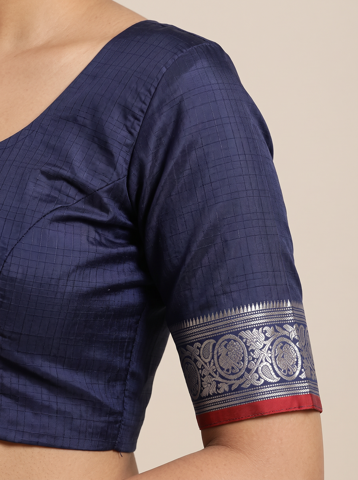 Like a lotus pond under moonlight, sea green silk shimmers with silver butas and fine checks, meeting navy depths and a silver tissue pallu full of zari blossoms. Handloom Gadwal.