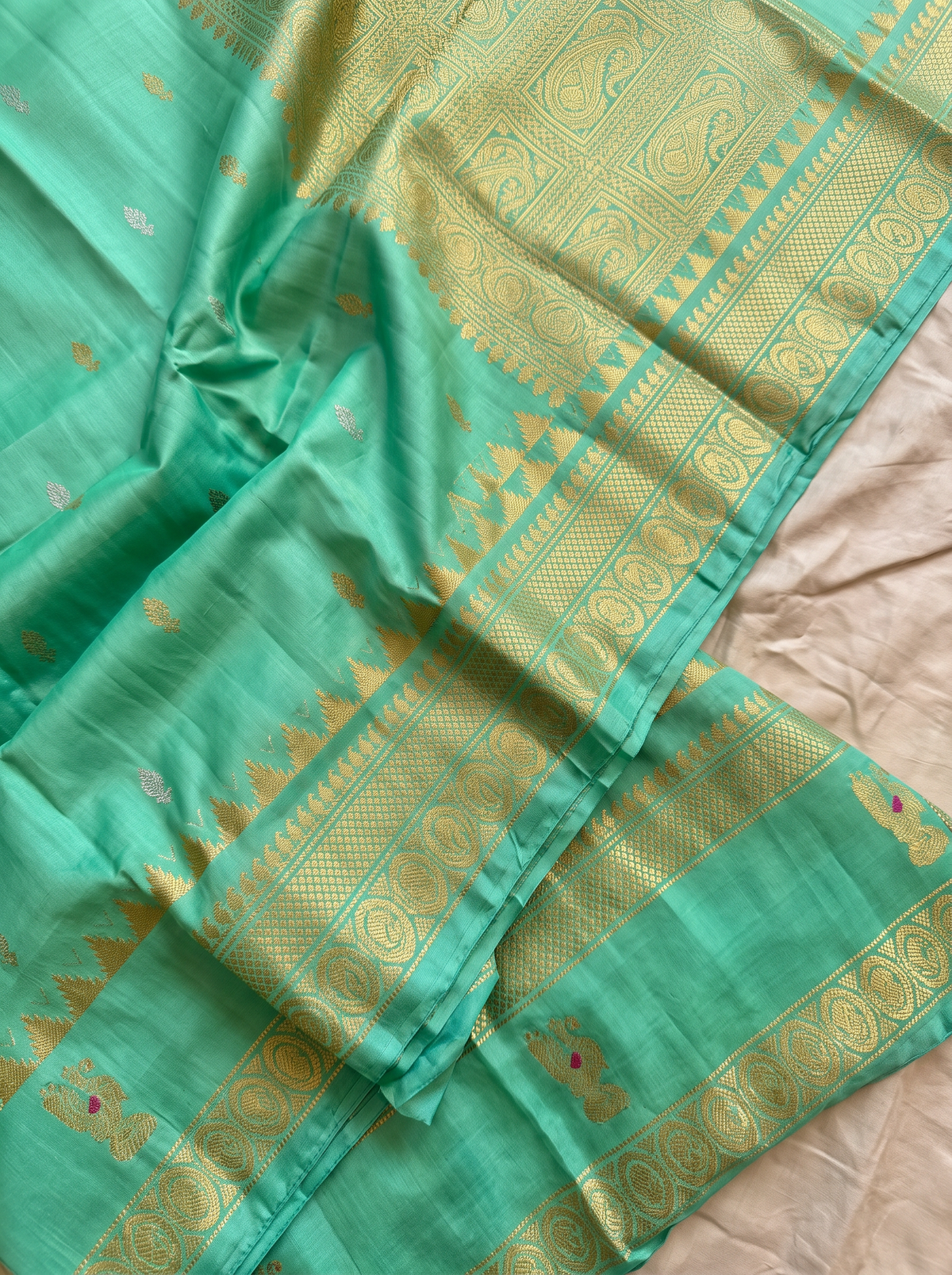 Serene green handloom Gadwal silk, sprinkled with gold and silver butis like stars on a quiet evening.