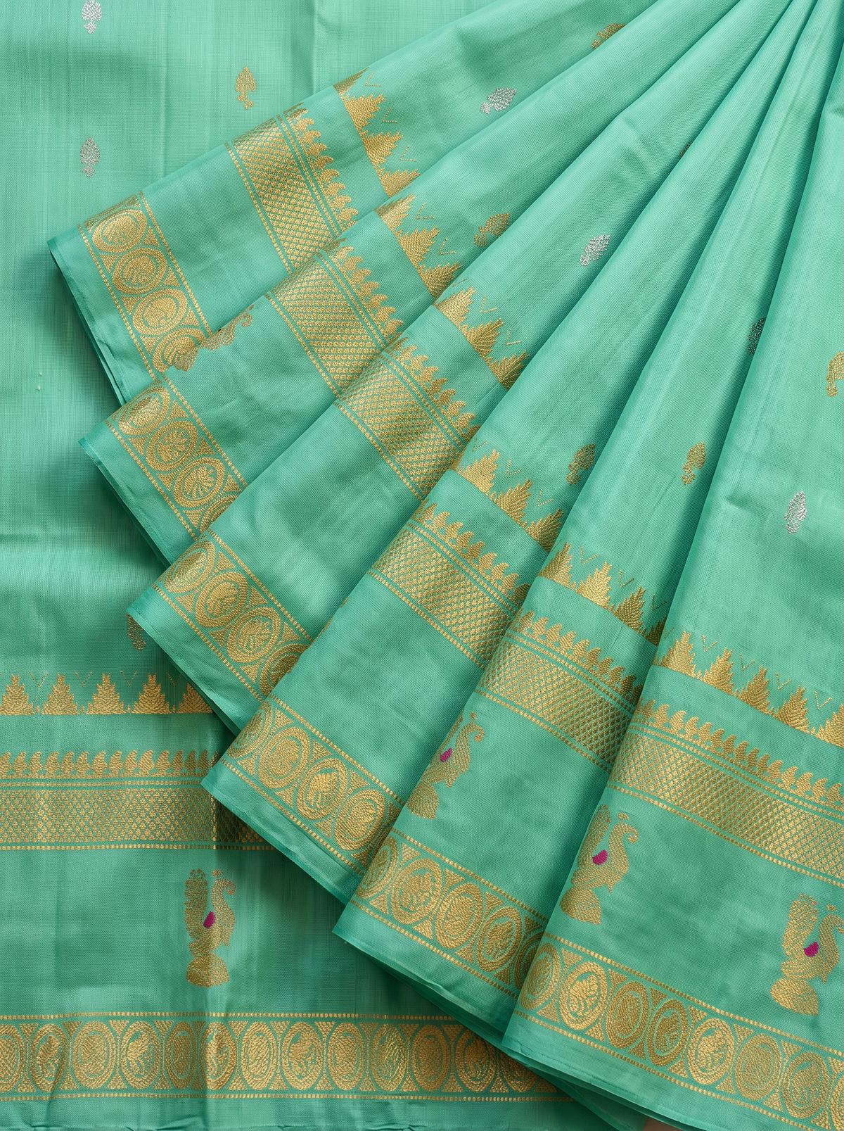 Serene green handloom Gadwal silk, sprinkled with gold and silver butis like stars on a quiet evening.