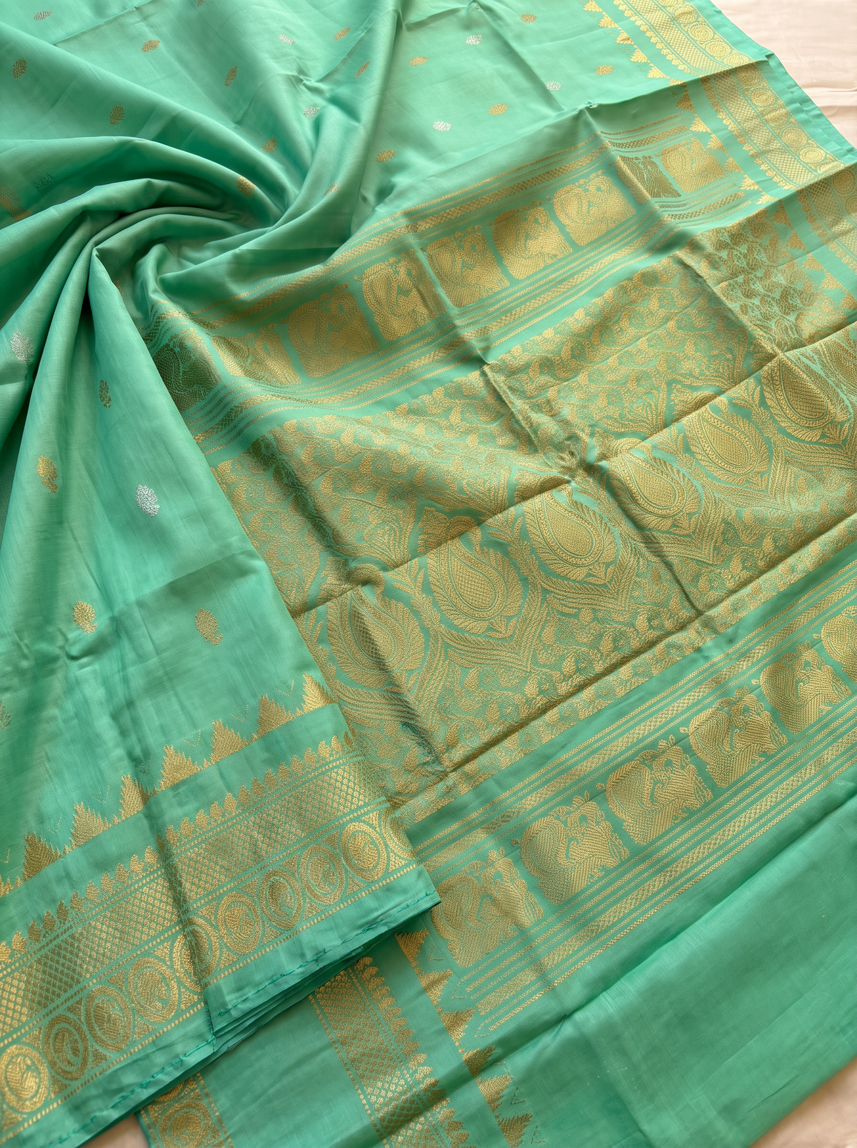 Serene green handloom Gadwal silk, sprinkled with gold and silver butis like stars on a quiet evening.