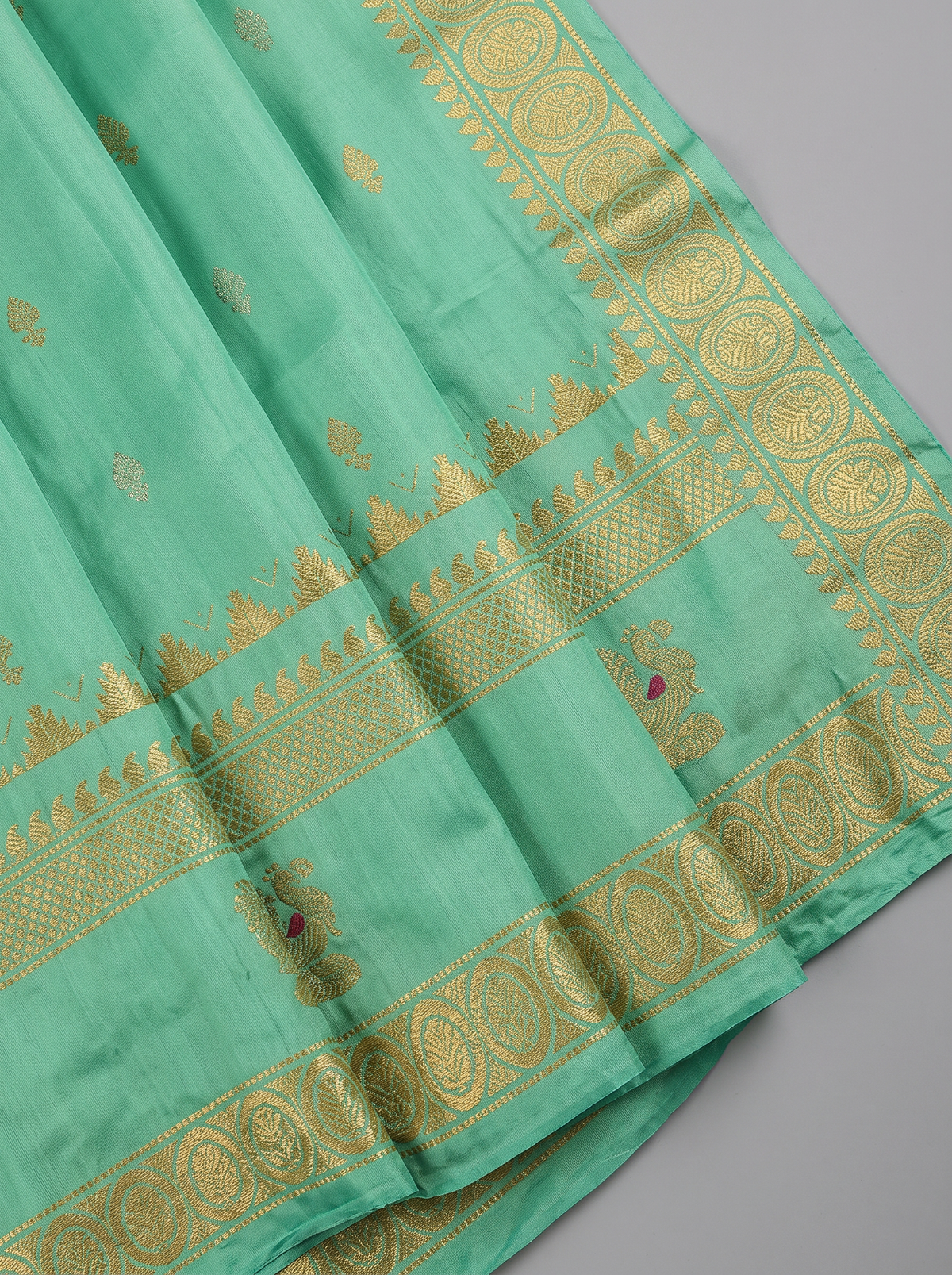 Serene green handloom Gadwal silk, sprinkled with gold and silver butis like stars on a quiet evening.