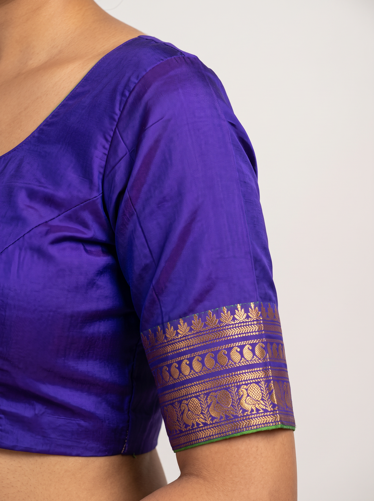 Like a clear midnight sky sprinkled with golden stars, this blue Gadwal silk is edged with peacocks and a blush of pink, finishing in a pallu rich with gold zari.