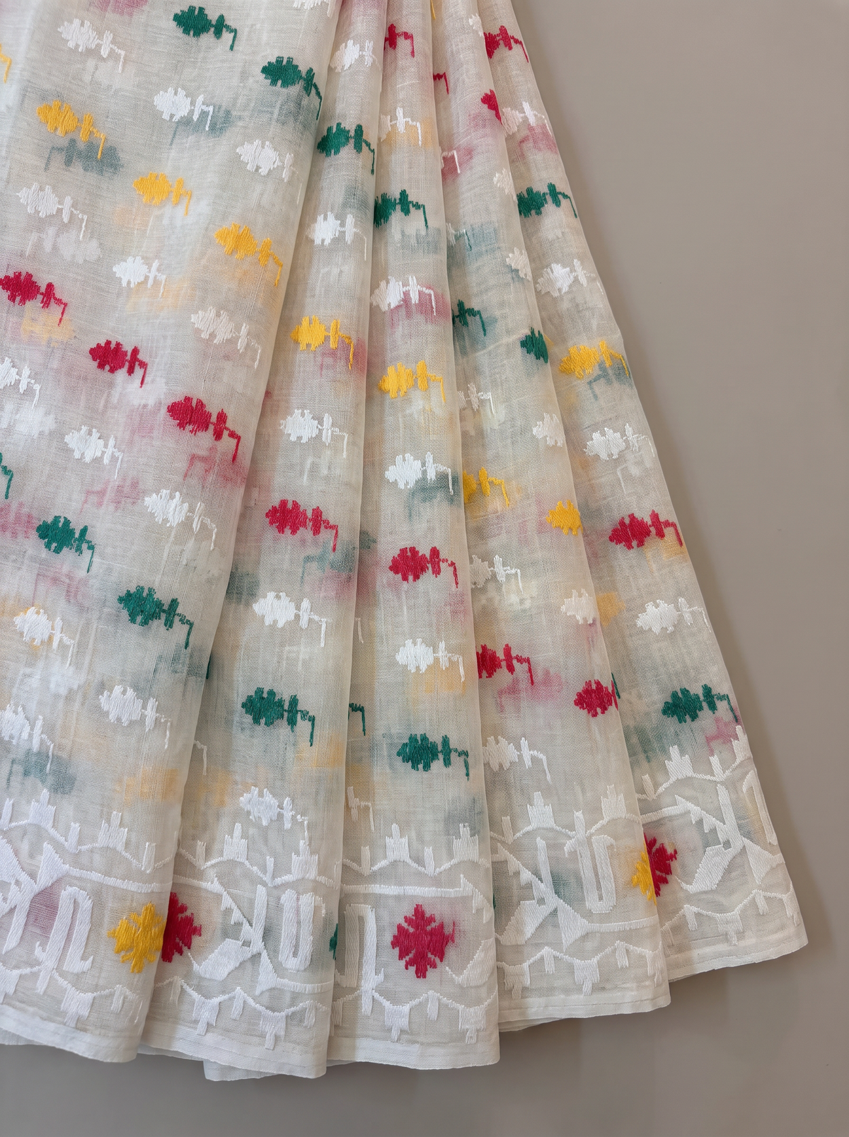Ivory White Dhakai Jamdani adorned with vibrant Red, Green, and Yellow motifs, delicate white weaving, and subtle multicolored striped accents.