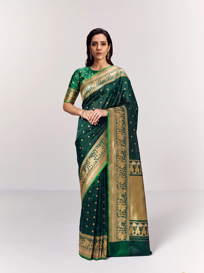 Gadwal - Handloom Gadwal silk in peacock green with tiny gold buttis. Its gold border and pallu glow with ceremonial processions and elephant friezes.