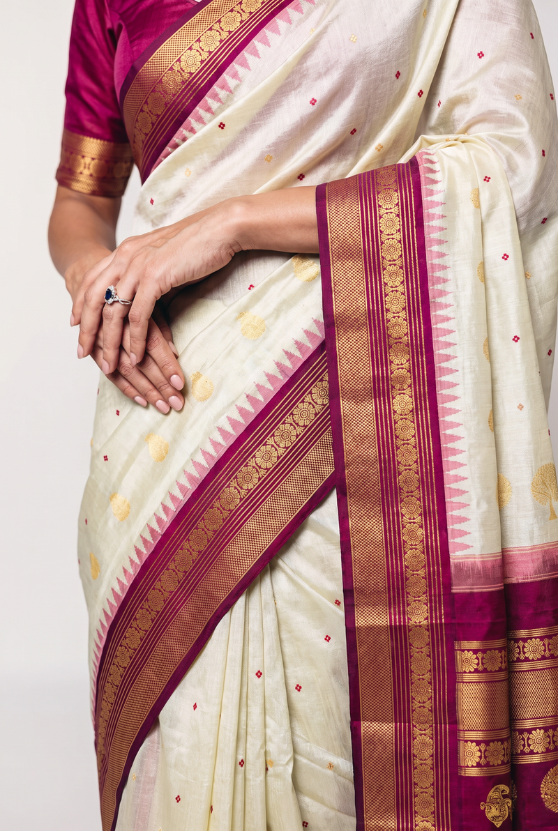 Gadwal - Silk Mark certified handloom Gadwal tissue silk in cream with red booti and golden thread tree butas. Its maroon border and pallu glow with thread-woven florals, entirely without zari.