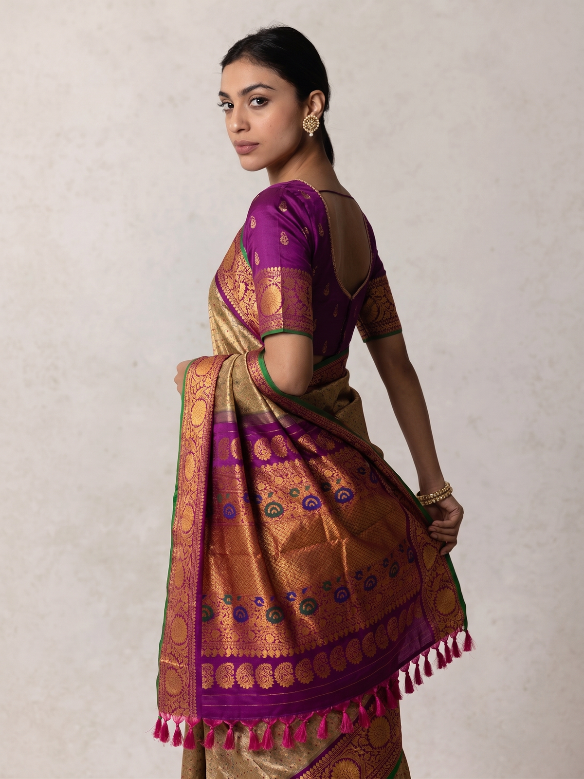 Gold-beige brocade melting into royal purple. A Kanchi-style border strewn with jewel-bright meenakari paisleys. Handwoven Gadwal silk from Telangana, as timeless as the looms that made it.