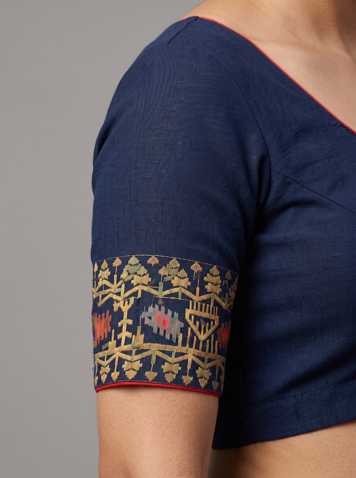 A Midnight Blue Dhakai Jamdani — Jewel-Toned Florals in Antique Gold, Coral, Muted Rose & Silver-Grey with a Vermilion-Red Edge