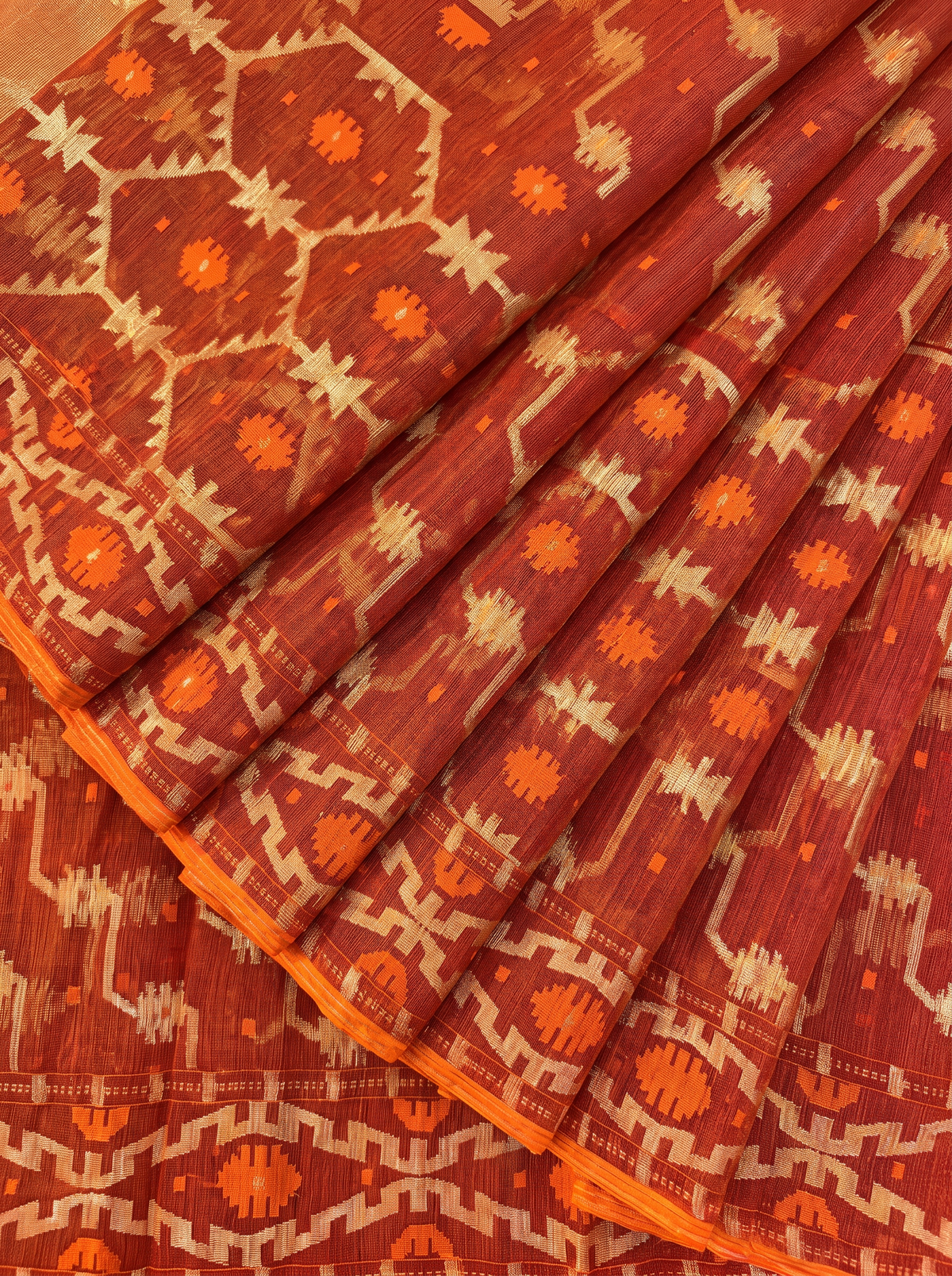 A Timeless Celebration of Dhakai Jamdani — Rich Burnt Rust Illuminated with Silver Zari & Warm Orange Accents
