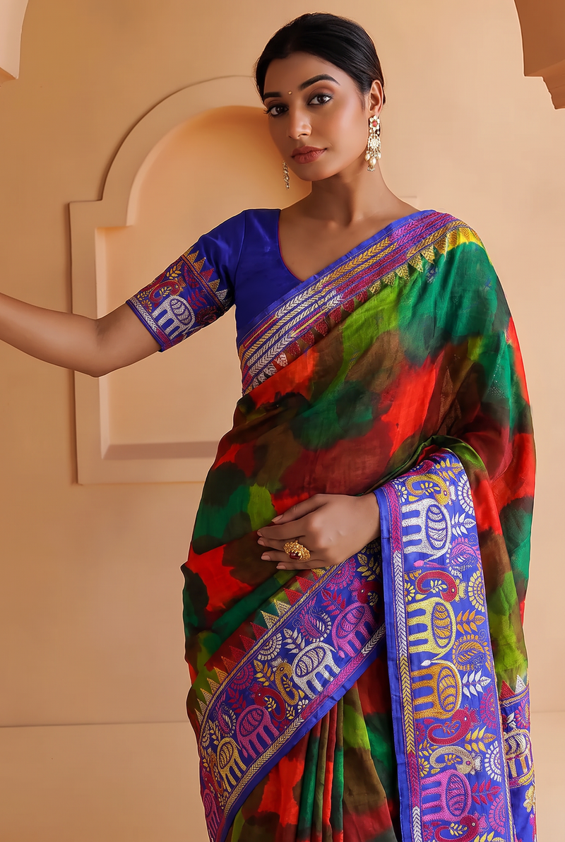 Royal blue silk carrying a love story in every stitch. Elephants sway, peacocks dance and palanquins drift home, until the pallu blushes into a hand-painted wash of red, green and blue.
