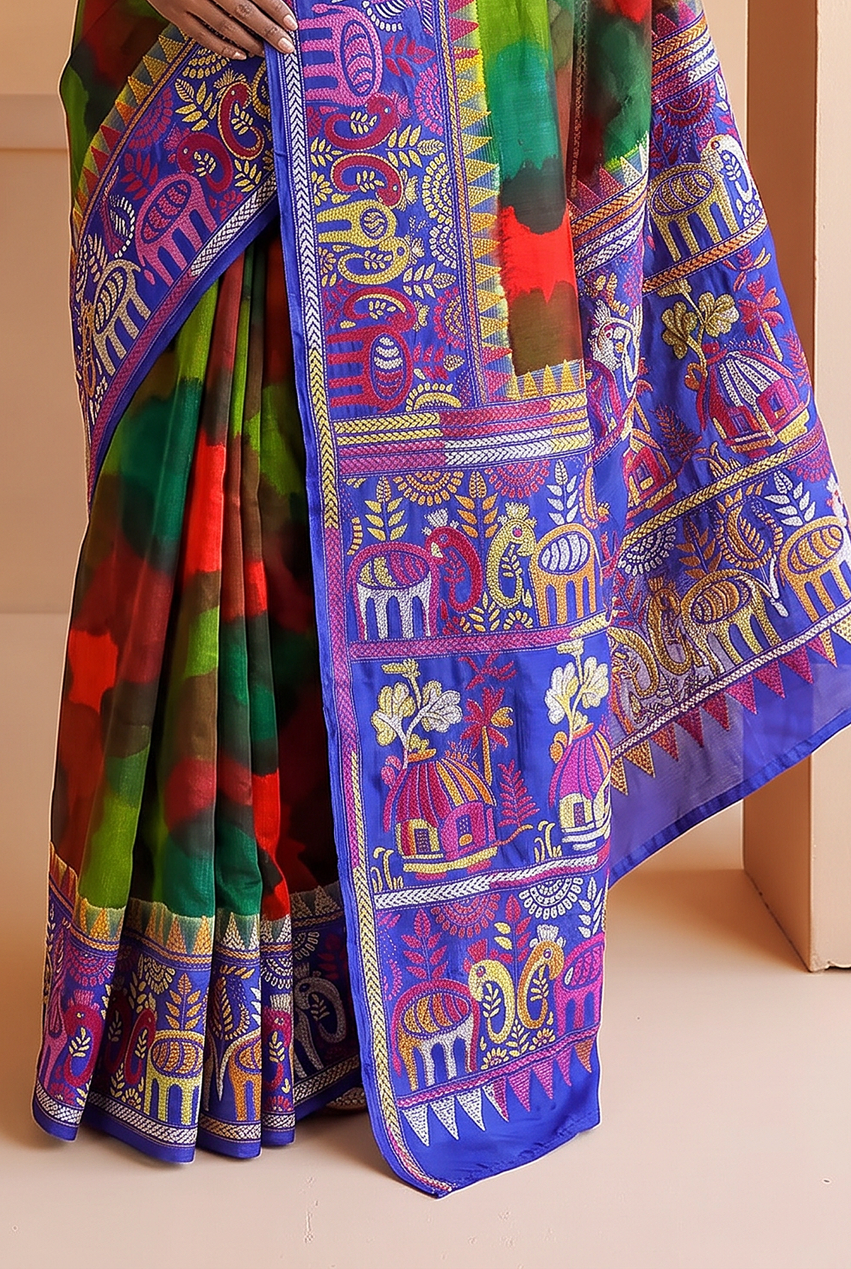 Royal blue silk carrying a love story in every stitch. Elephants sway, peacocks dance and palanquins drift home, until the pallu blushes into a hand-painted wash of red, green and blue.