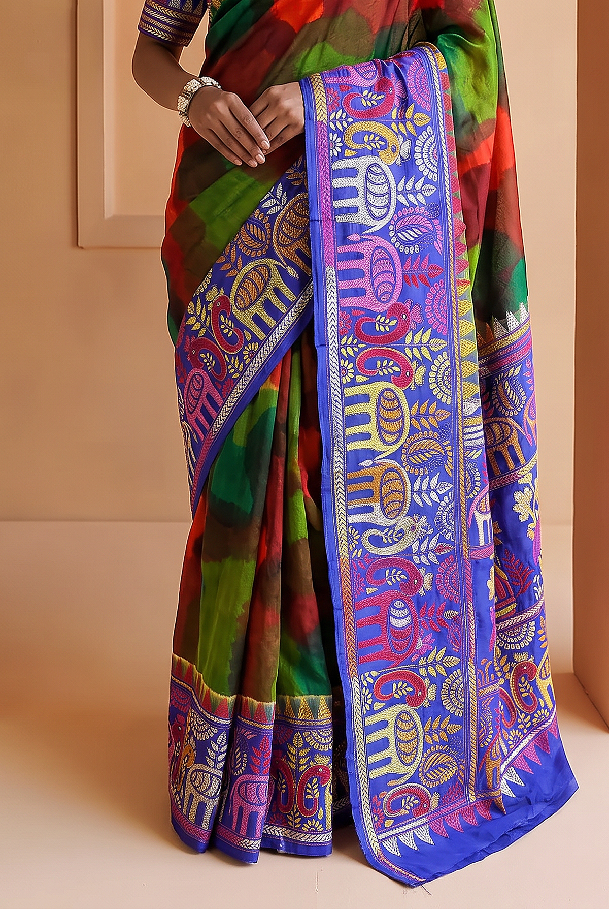Royal blue silk carrying a love story in every stitch. Elephants sway, peacocks dance and palanquins drift home, until the pallu blushes into a hand-painted wash of red, green and blue.