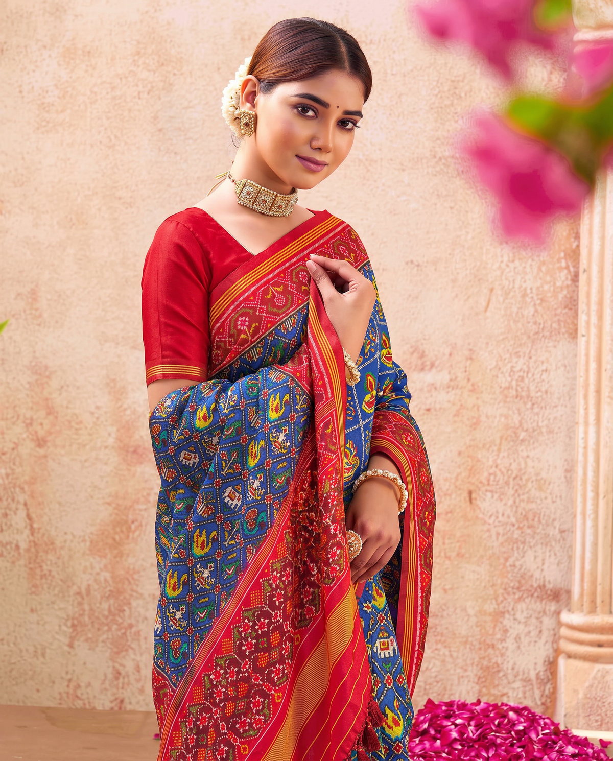 Royal blue, a miniature parade of elephants and peacocks, a red and gold farewell. Handloom Rajkot Patola from Gujarat.