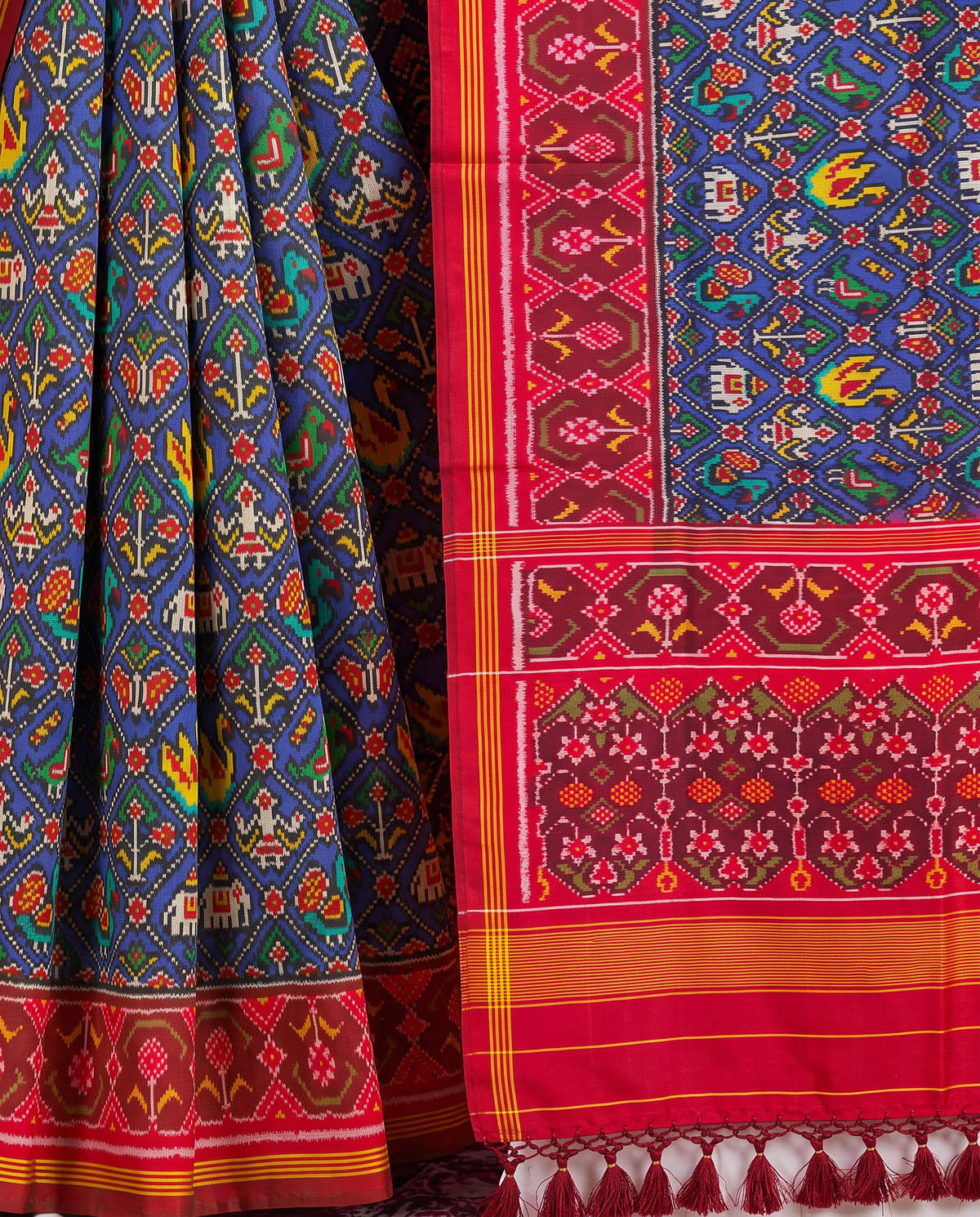 Royal blue, a miniature parade of elephants and peacocks, a red and gold farewell. Handloom Rajkot Patola from Gujarat.