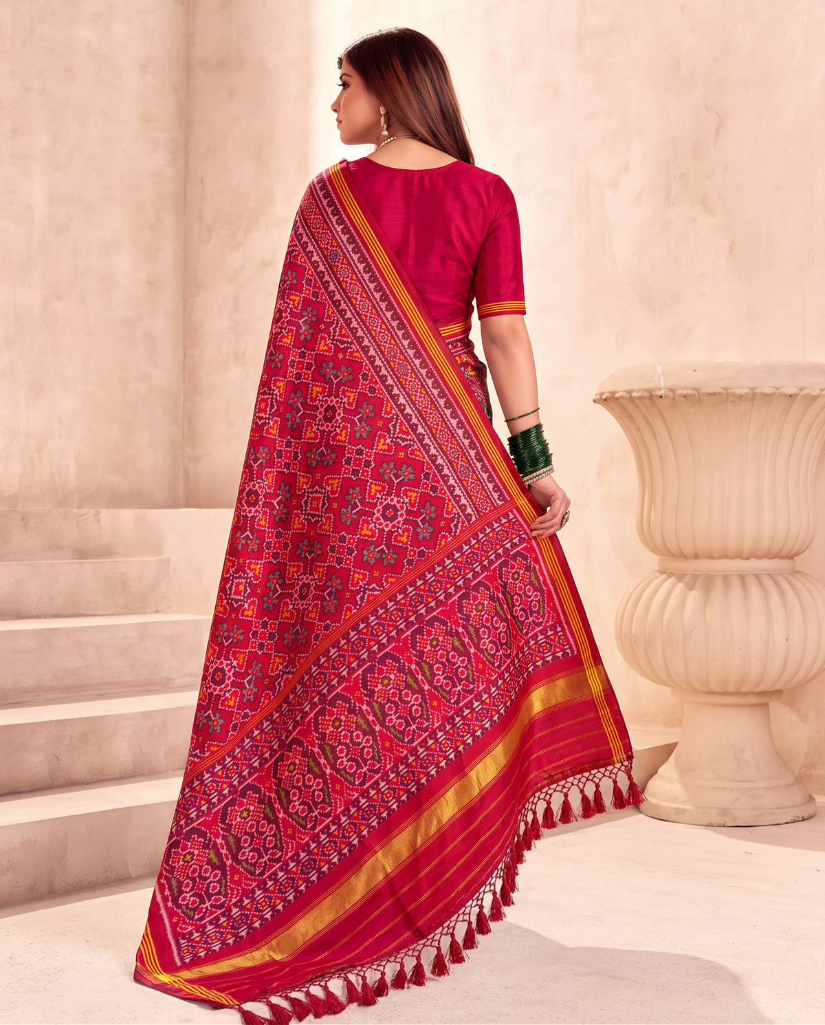 A red jewel box of hearts, blossoms and stars, finished in a glow of gold. Handloom single ikat Patola from Gujarat.