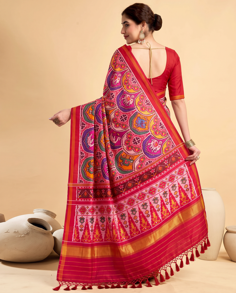 Red silk in full bloom, jewel-toned rosettes guarded by tiny golden elephants. Handloom Patola from Gujarat.