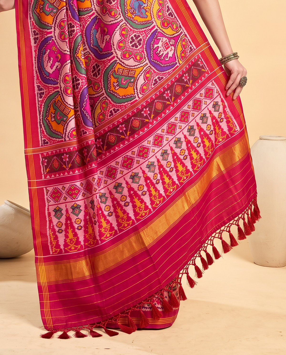 Red silk in full bloom, jewel-toned rosettes guarded by tiny golden elephants. Handloom Patola from Gujarat.