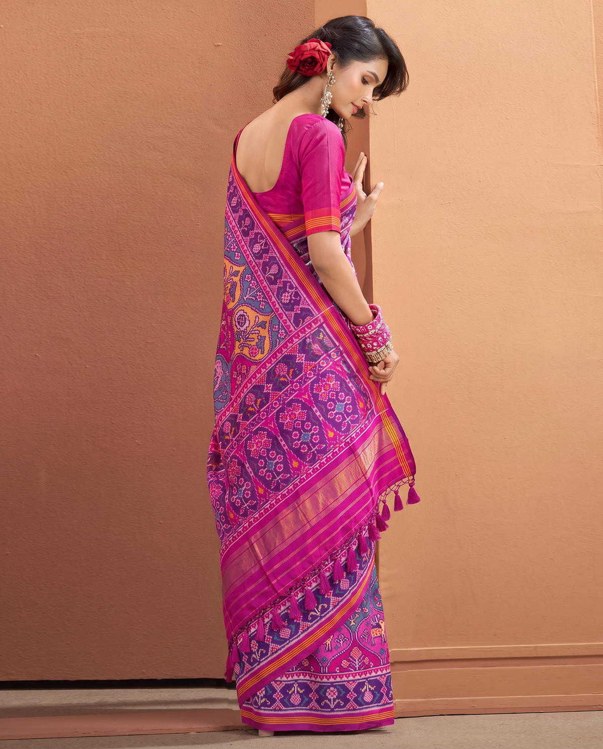 A Matka garden in magenta, where elephants and deer wander among flowering trees toward gold. Handloom Rajkot Patola from Gujarat.