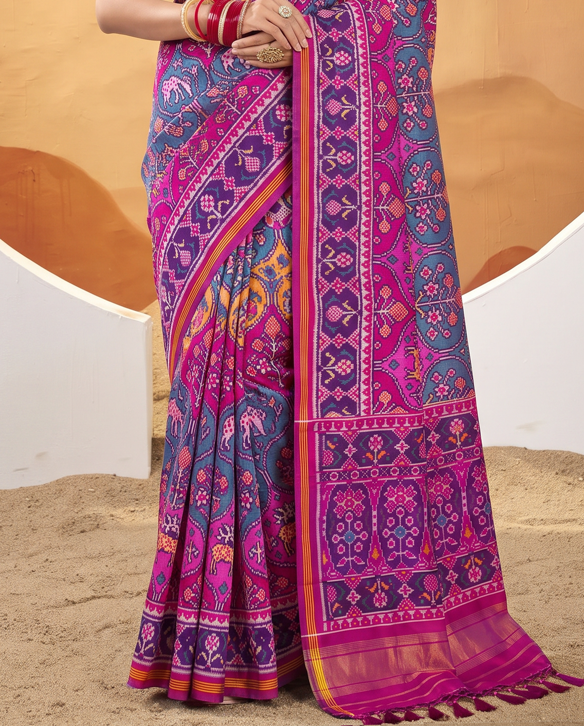 A Matka garden in magenta, where elephants and deer wander among flowering trees toward gold. Handloom Rajkot Patola from Gujarat.