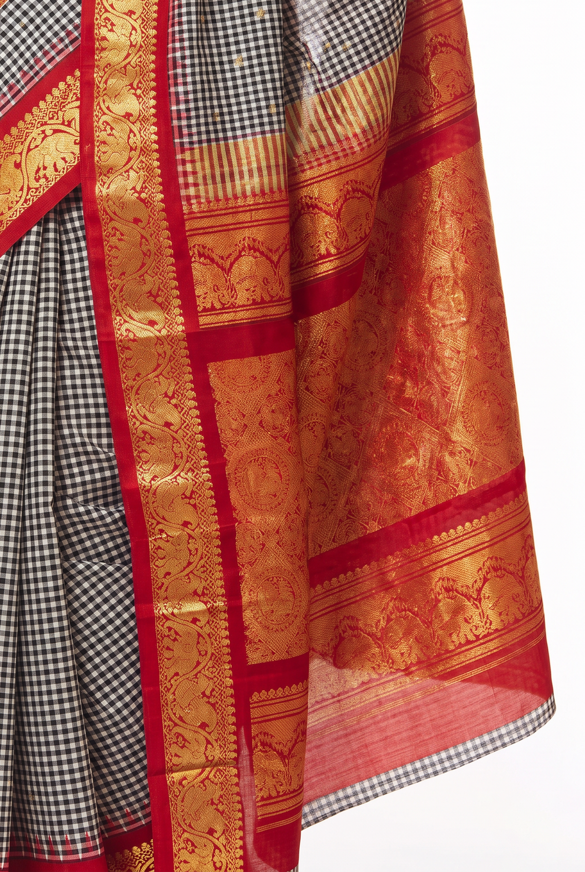 Monochrome checks, a flash of red, and golden elephants and peacocks. Handloom Gadwal silk.