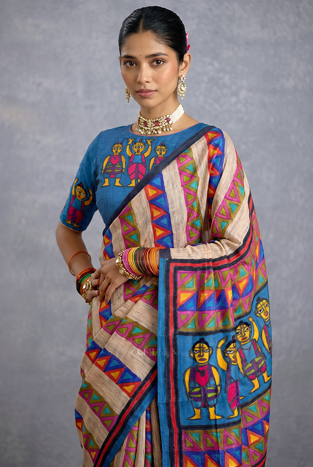 Beige-gold Tussar meets a slate blue field, where hand-stitched folk figures dance in rows, framed by bright bands of geometric triangles. Silk Mark certified handcrafted Tussar silk Kantha.